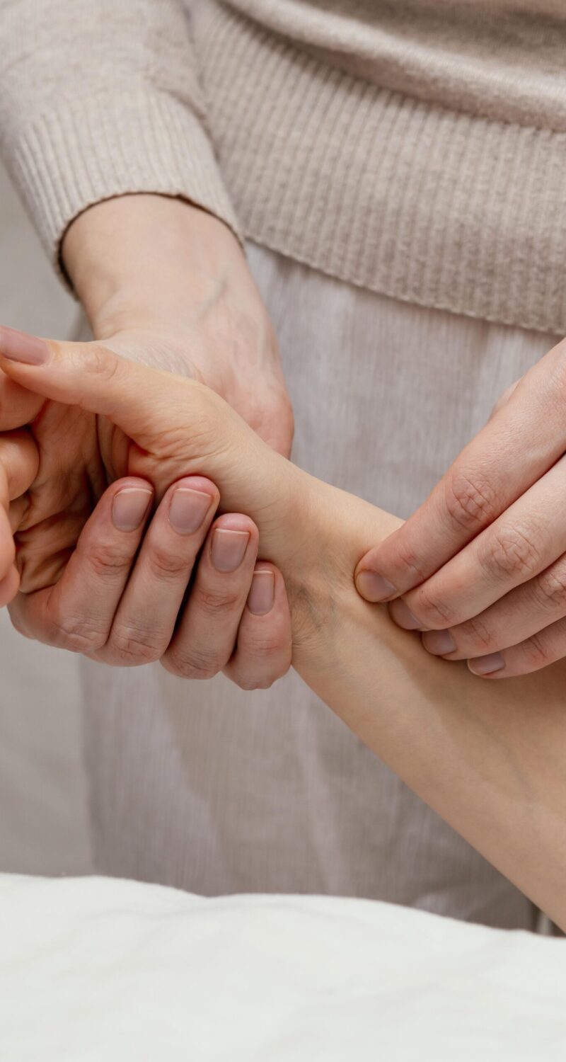 close-up-therapist-massaging-arm